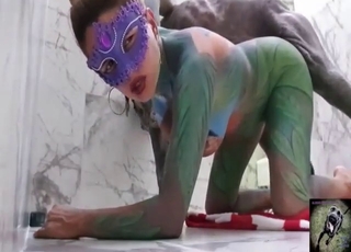Girl in the oddest bodysuit bangs her dog